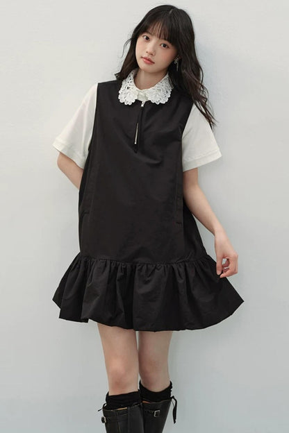 Vestido negro con cremallera y bajo con volantes