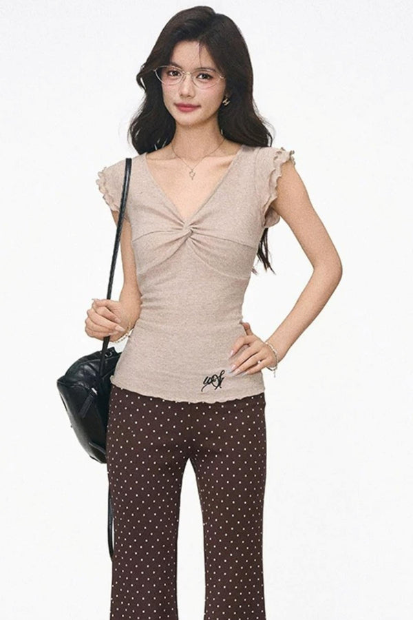 Conjunto de top de punto con mangas volantes y pantalones de lunares