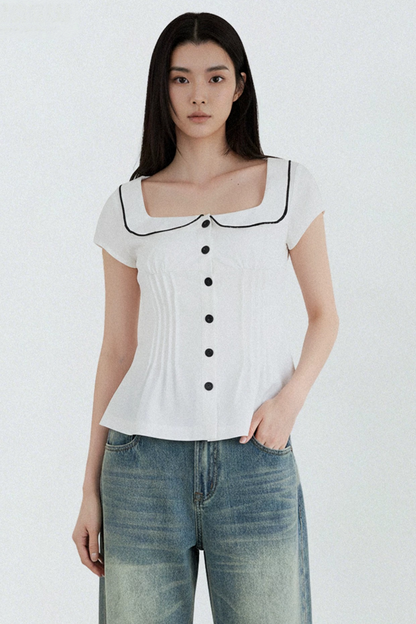 Blusa con cuello de muñeca con bloques de color