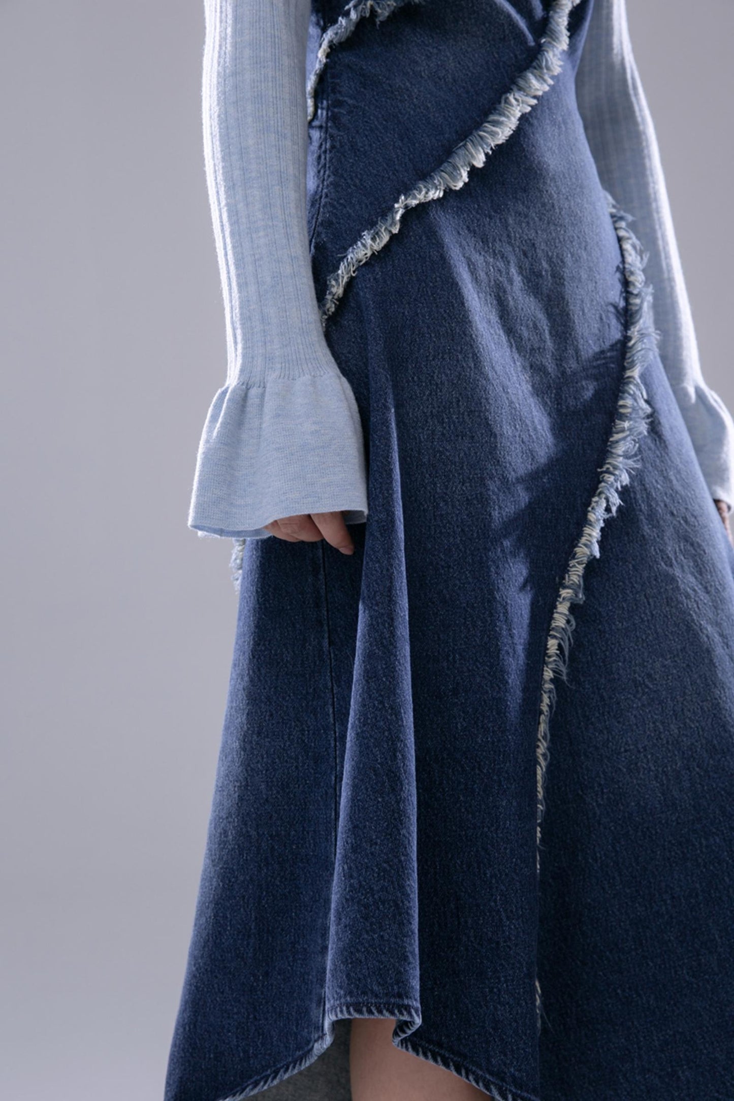 COTRE is a stunningly proportioned aqua blue denim dress with raw edges