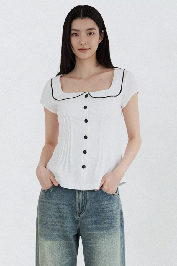 Blusa con cuello de muñeca con bloques de color