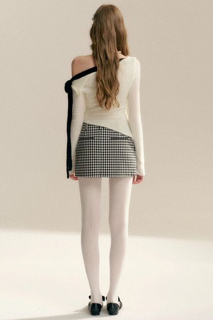 Pull épaules dénudées avec nœud asymétrique