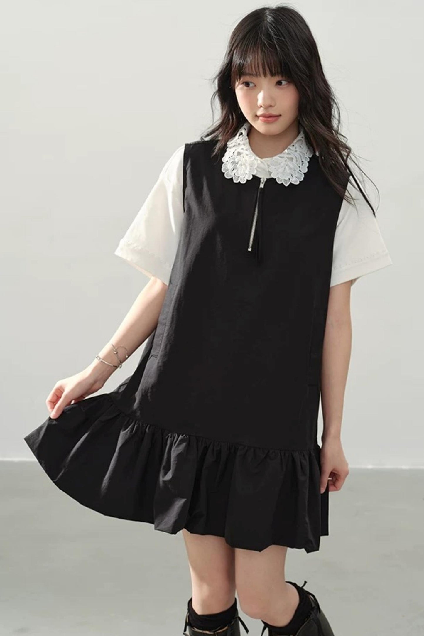 Vestido negro con cremallera y bajo con volantes