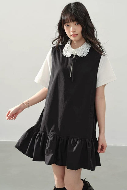 Vestido negro con cremallera y bajo con volantes
