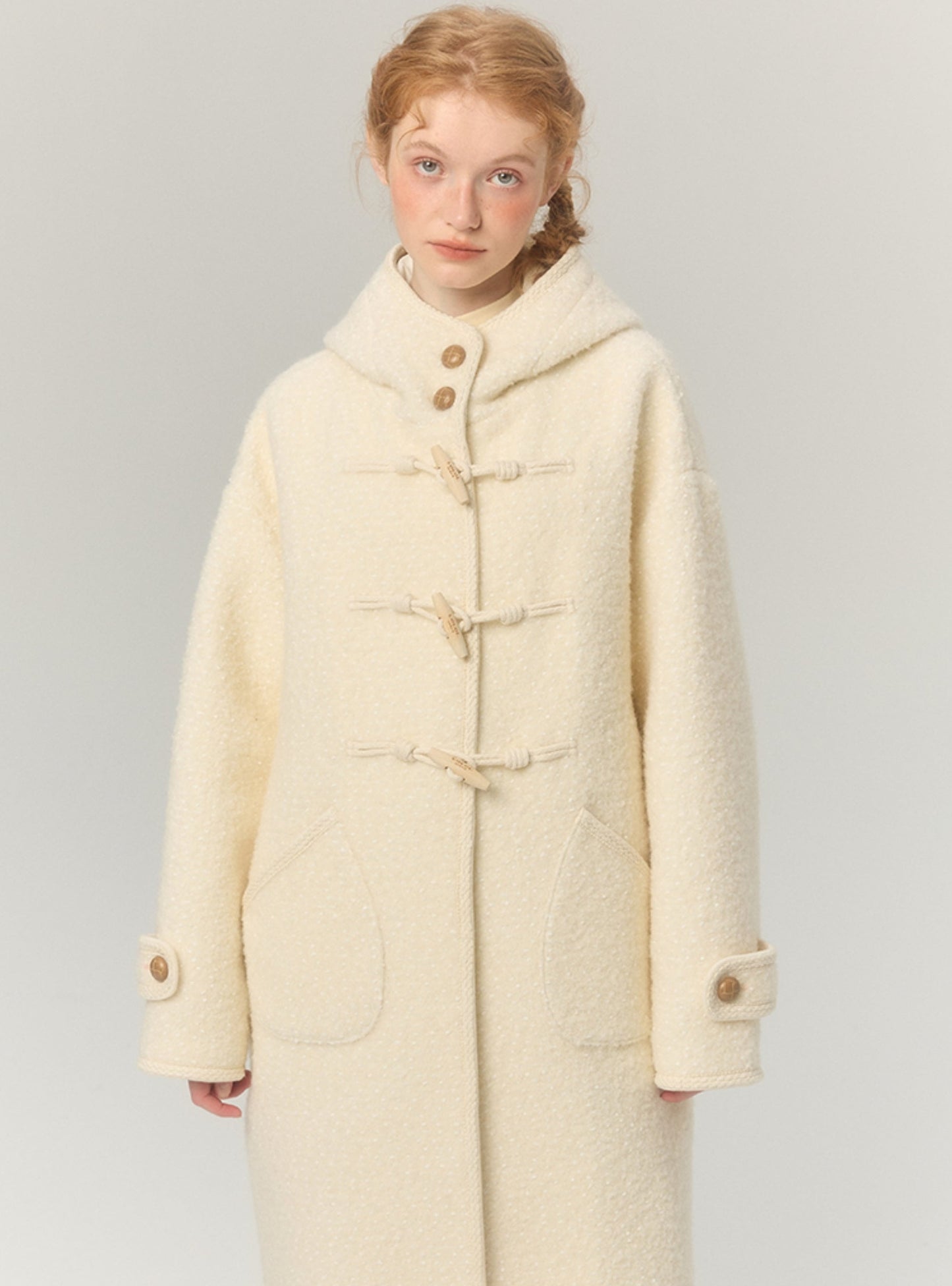Long thickened hooded horn-buttoned tweed coat