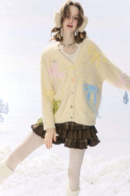Cardigan in maglia soffice color albicocca con fiocco