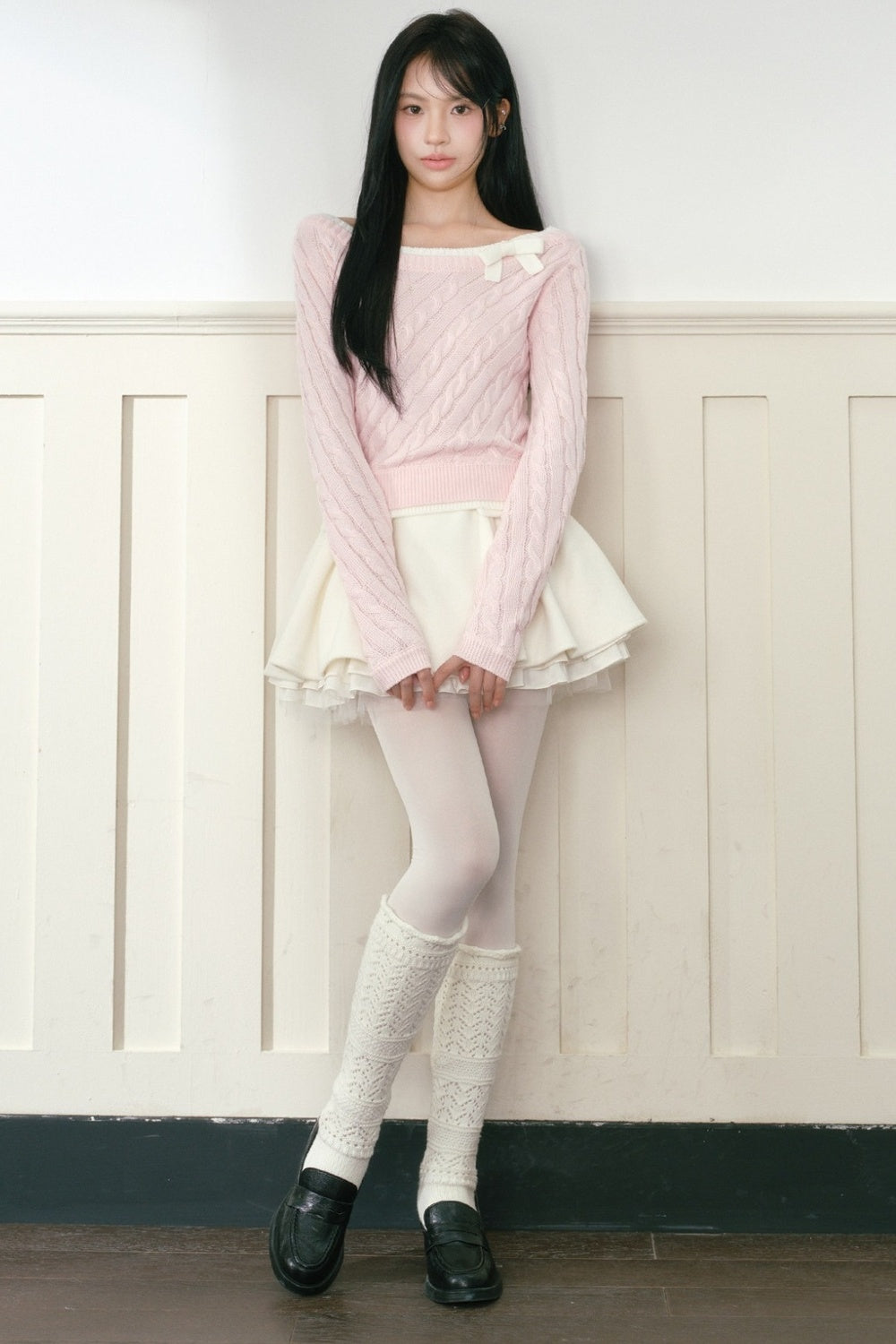 Pull en maille torsadée rose à nœud