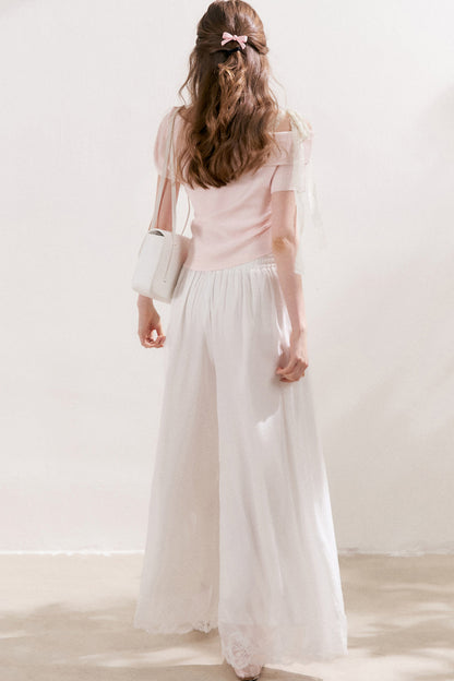 Top in maglia con spalle scoperte e fiocco in pizzo