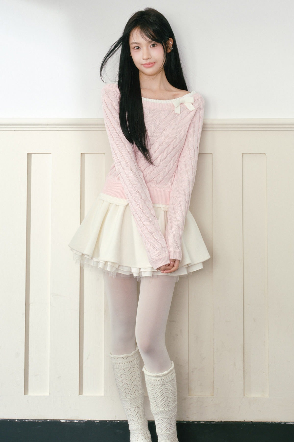 Pull en maille torsadée rose à nœud