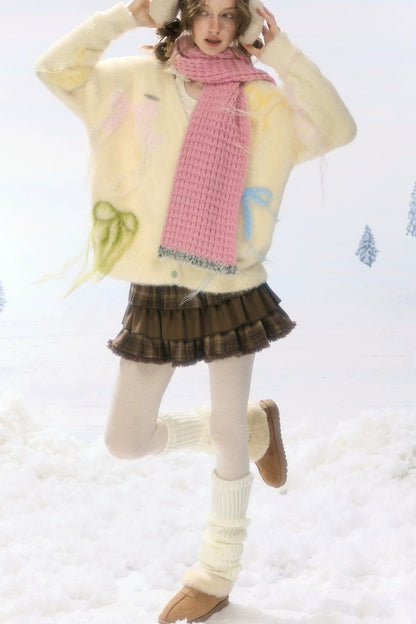 Cardigan in maglia soffice color albicocca con fiocco