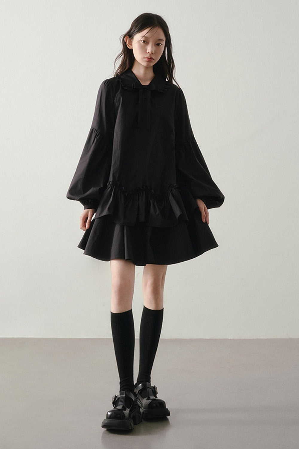 Robe noire asymétrique à volants et manches lanternes