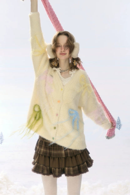 Cardigan in maglia soffice color albicocca con fiocco