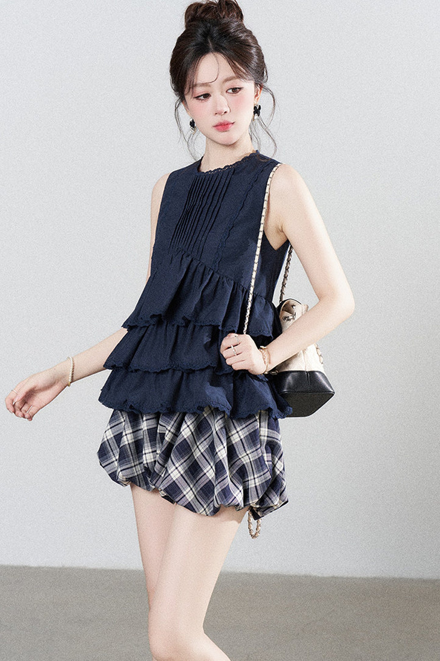Conjunto de camisa azul marino con volantes y falda de cuadros