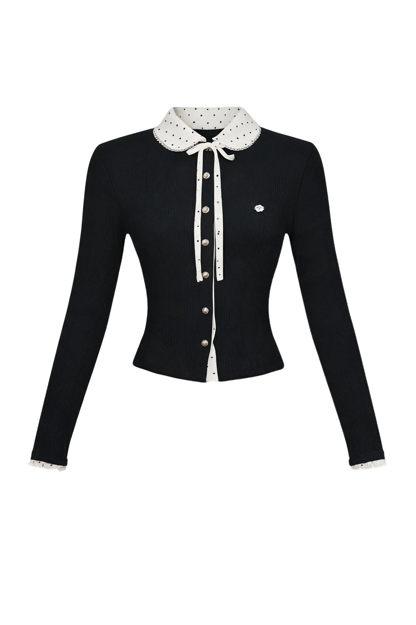 Completo con top in maglia a maniche lunghe e gonna a pois con toppe