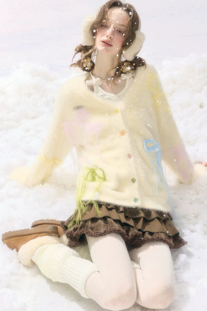 Cardigan in maglia soffice color albicocca con fiocco