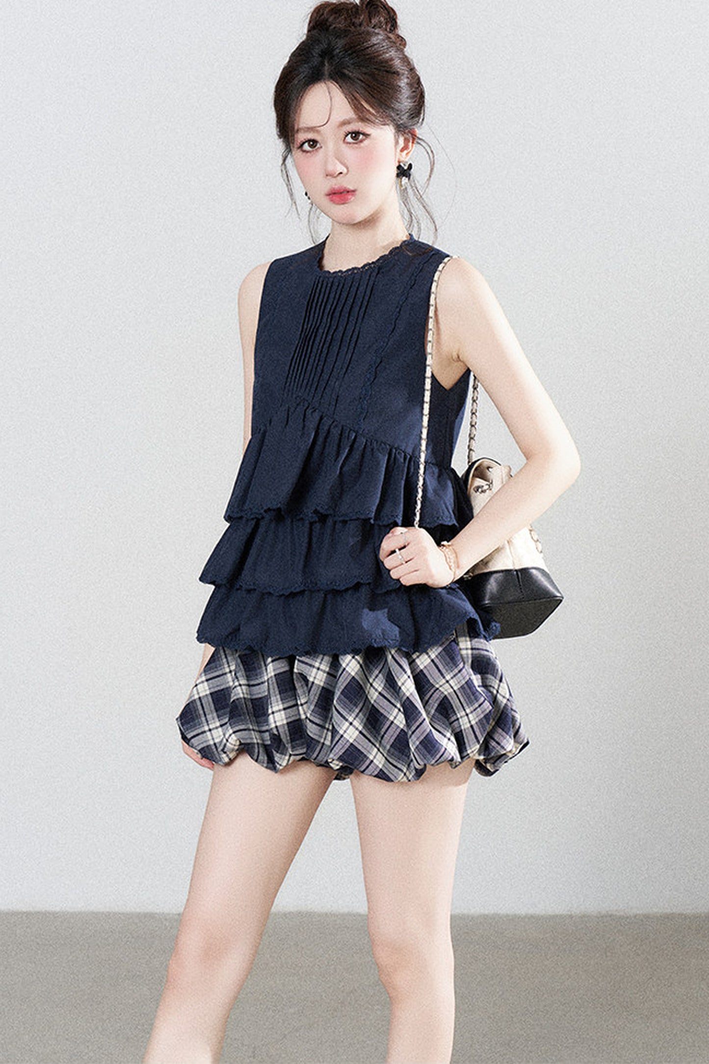 Conjunto de camisa azul marino con volantes y falda de cuadros