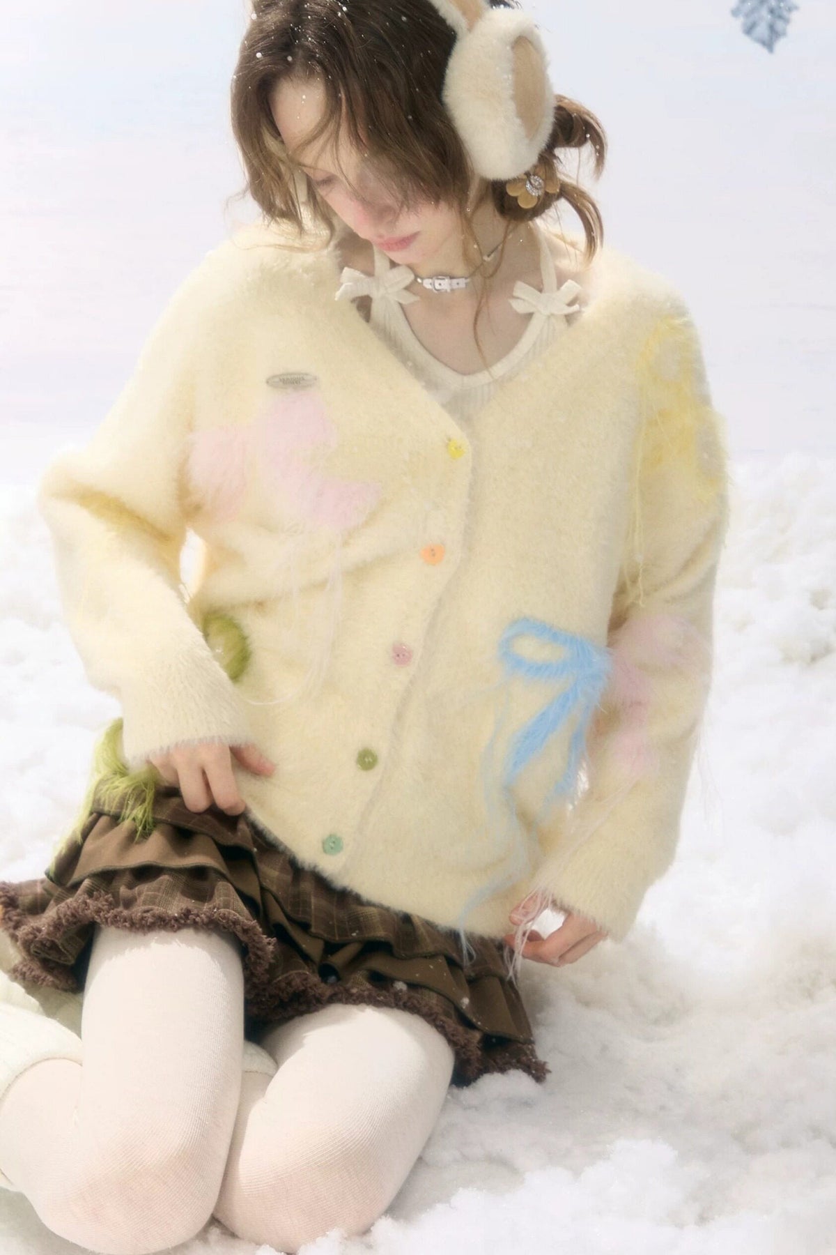 Cardigan in maglia soffice color albicocca con fiocco