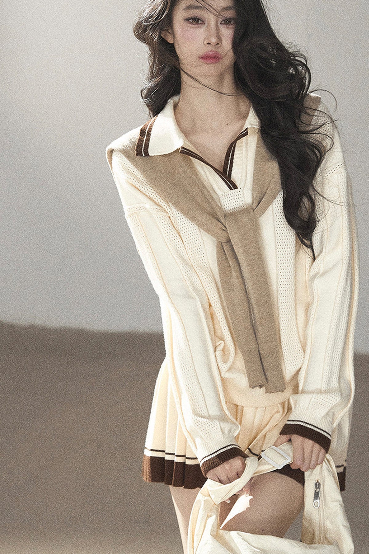 Completo con top a maglia, gonna corta plissettata e giacca