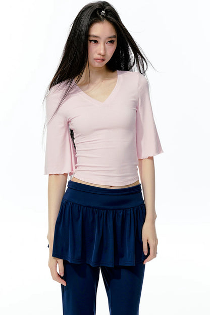 Completo rosa con top a maniche a campana e pantaloni da yoga